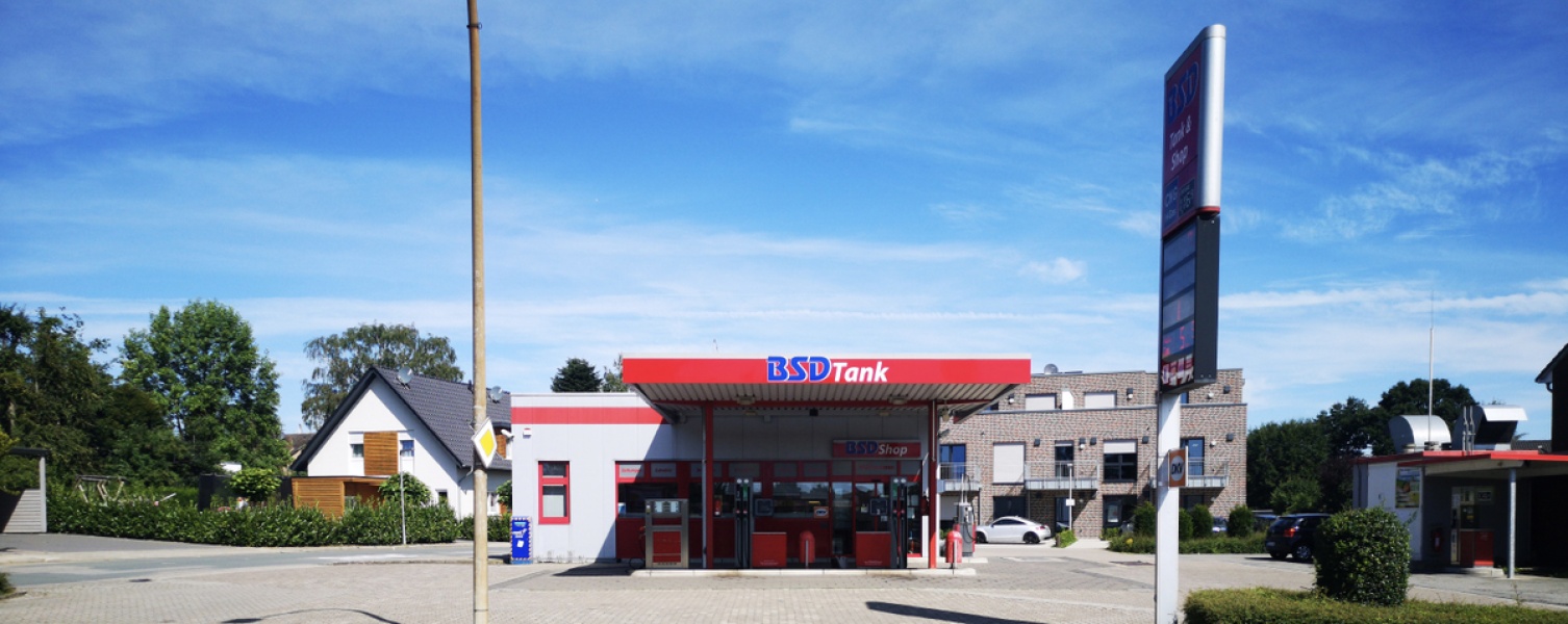 Firmengebäude mit Tankstelle im Vordergrund